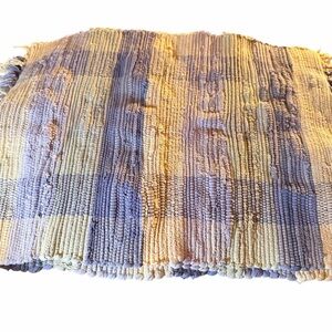 This is a hand-woven pastel and white tartan-like pattern placemat
